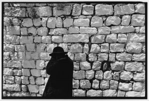 Black Coat White Wall, Jerusalem, Israel, 1967 by Leonard Freed