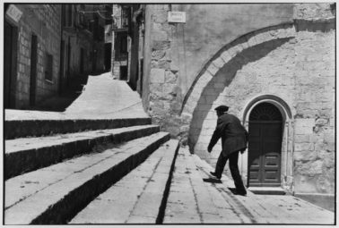 Man climbs stairs, Madonie Mountains, Petralina Sottana, Sicily, Italy, 1974 by Leonard Freed